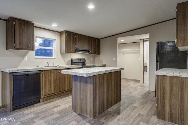 kitchen with sink, ventilation hood, light hardwood / wood-style floors, a kitchen island, and black appliances