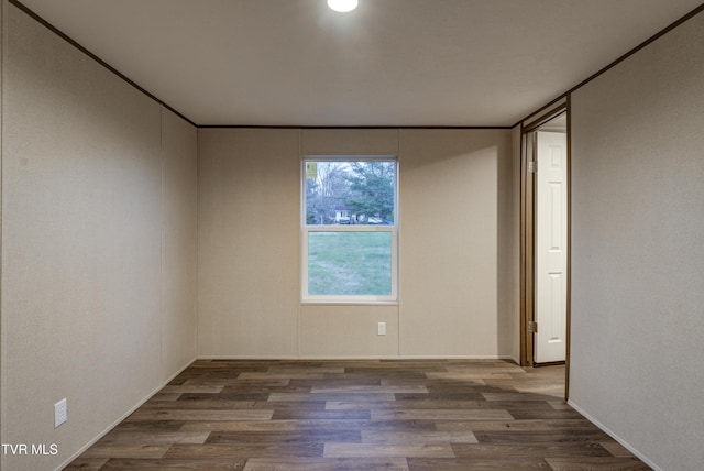 spare room featuring dark hardwood / wood-style floors