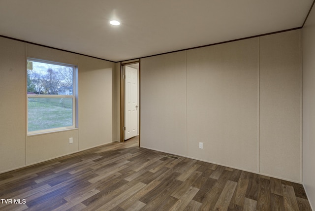 spare room with dark hardwood / wood-style flooring