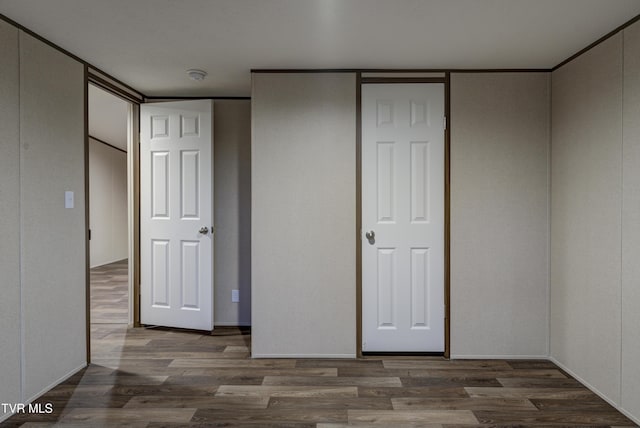 unfurnished bedroom featuring dark wood-type flooring