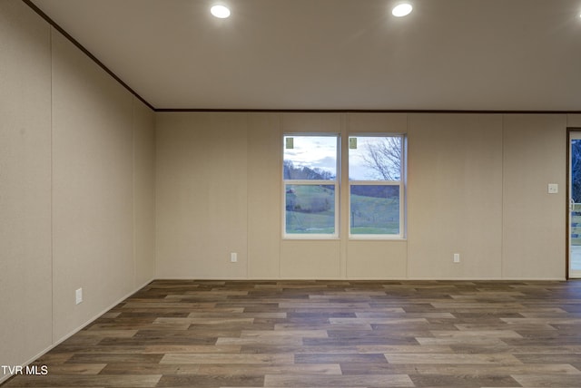 unfurnished room with wood-type flooring and crown molding