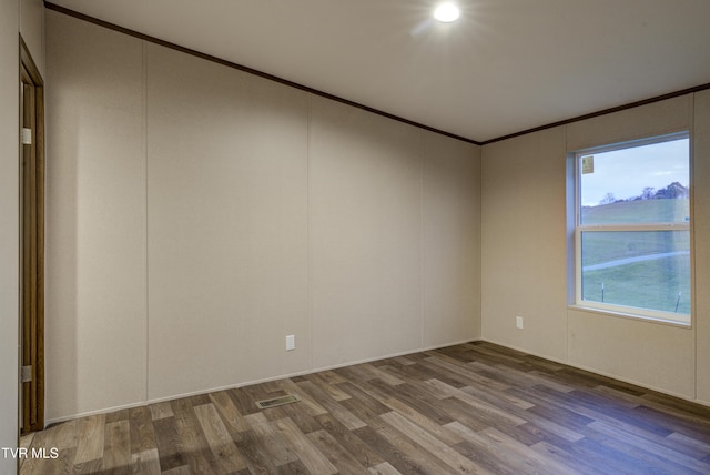 unfurnished room with crown molding and hardwood / wood-style floors