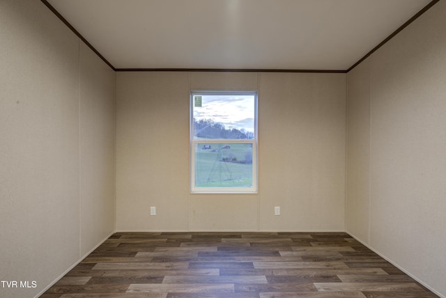 unfurnished room featuring dark hardwood / wood-style flooring and ornamental molding