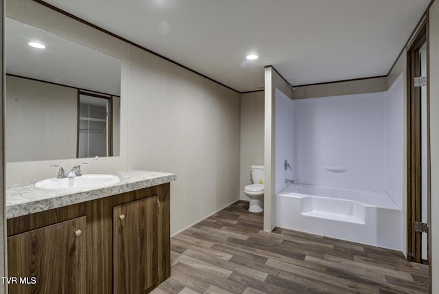 full bathroom featuring shower / tub combination, vanity, hardwood / wood-style flooring, and toilet