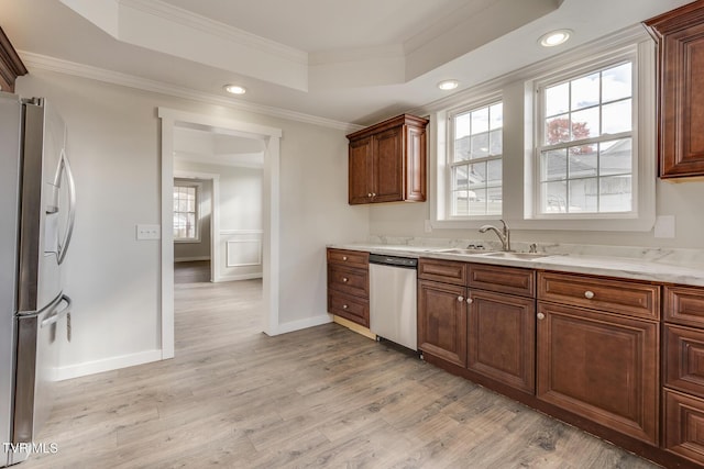 kitchen featuring light hardwood / wood-style floors, sink, ornamental molding, and appliances with stainless steel finishes