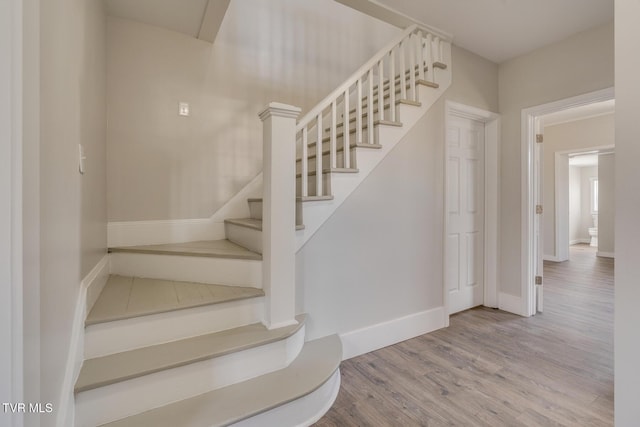 stairway with hardwood / wood-style flooring