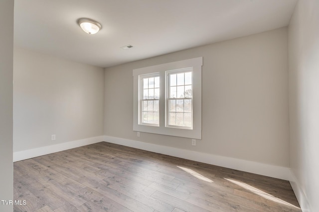 unfurnished room with light wood-type flooring