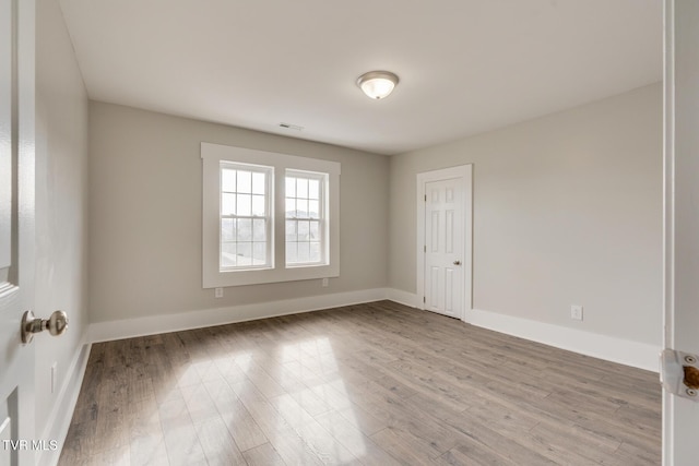 spare room featuring light hardwood / wood-style floors