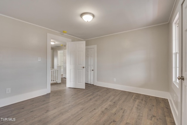 unfurnished bedroom featuring hardwood / wood-style floors and crown molding