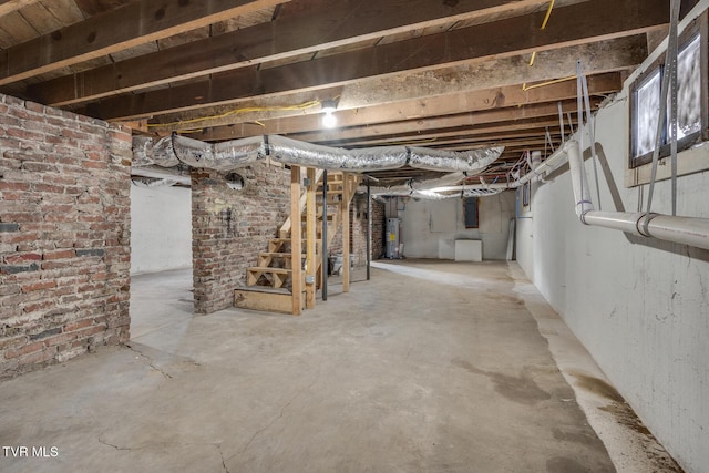 basement with water heater and brick wall