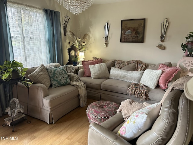 living room featuring an inviting chandelier and light wood-type flooring