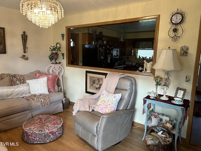 living room featuring hardwood / wood-style floors and a chandelier