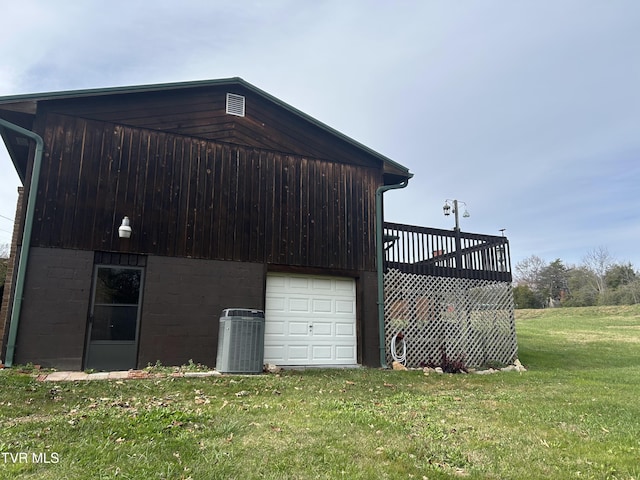 exterior space featuring a lawn and central AC unit