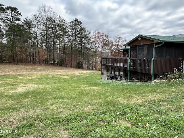 view of yard featuring a deck and a sunroom