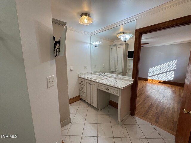 bathroom with crown molding, vanity, and wood-type flooring