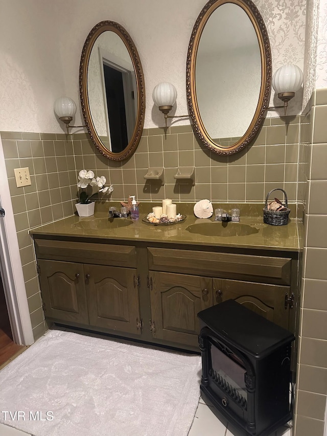 bathroom featuring vanity and tile walls