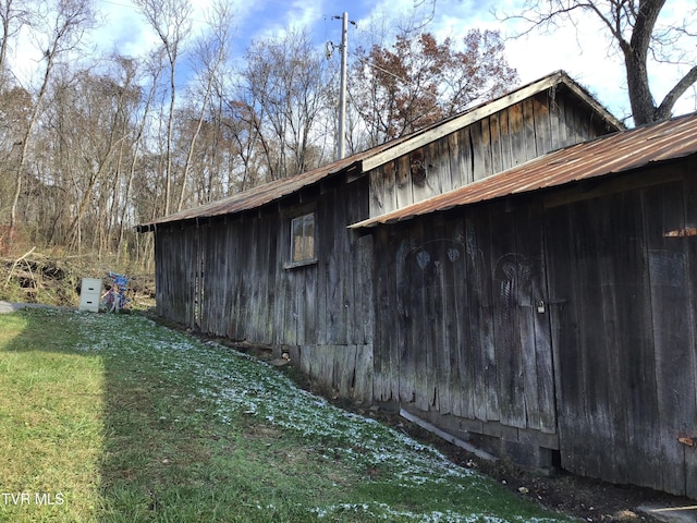 view of side of home featuring a lawn