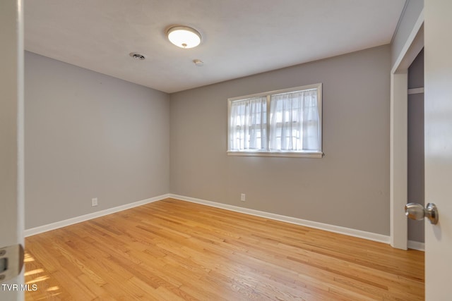 unfurnished room with light hardwood / wood-style floors