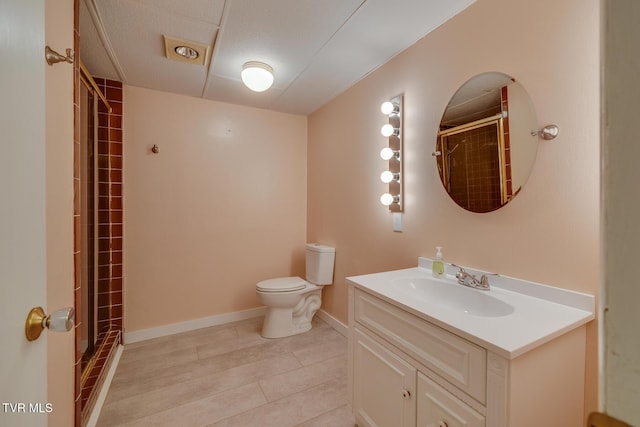 bathroom featuring toilet, a shower, and vanity