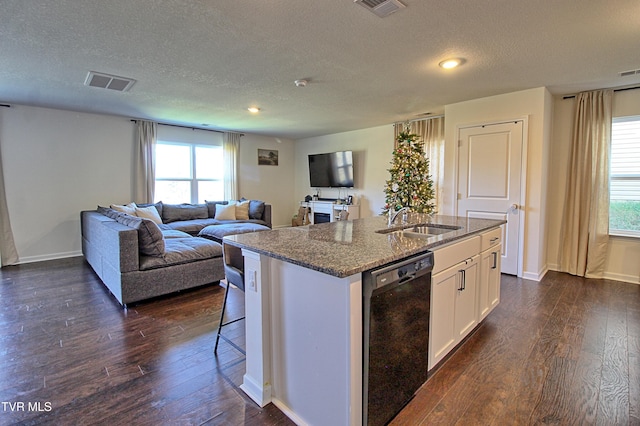 kitchen featuring white cabinets, dishwasher, sink, and an island with sink