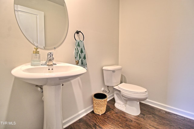 bathroom with hardwood / wood-style floors and toilet