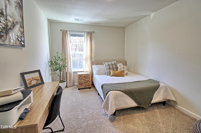 carpeted bedroom with a textured ceiling