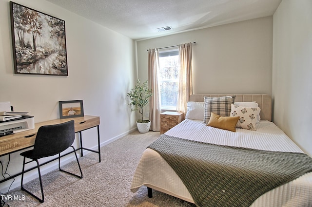 carpeted bedroom with a textured ceiling