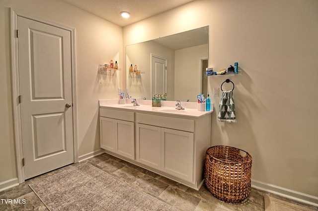 bathroom featuring vanity and a textured ceiling