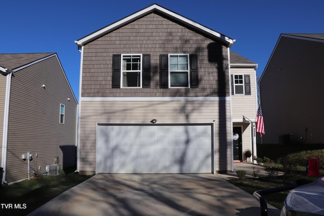 view of front facade with a garage and cooling unit