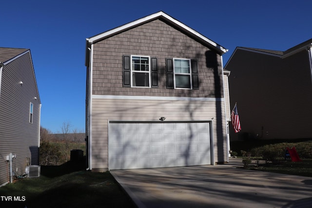 view of front of house with a garage and central air condition unit