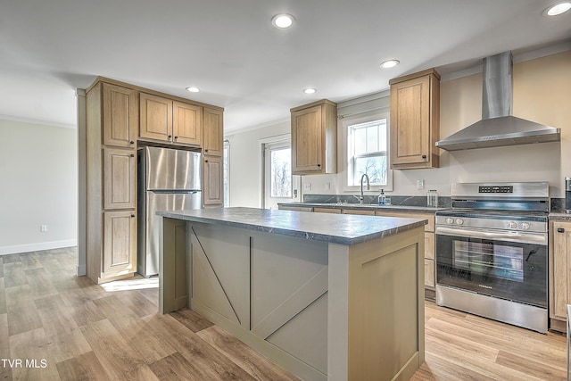 kitchen featuring stainless steel appliances, a kitchen island, wall chimney exhaust hood, and light hardwood / wood-style flooring