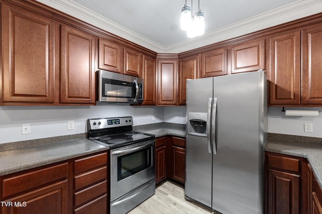 kitchen featuring hanging light fixtures, ornamental molding, light wood-type flooring, and appliances with stainless steel finishes