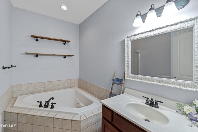 bathroom with vanity and tiled tub