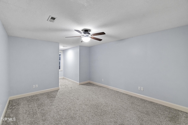 unfurnished room featuring light colored carpet and a textured ceiling