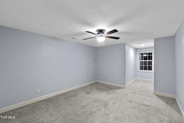 carpeted empty room featuring a textured ceiling and ceiling fan