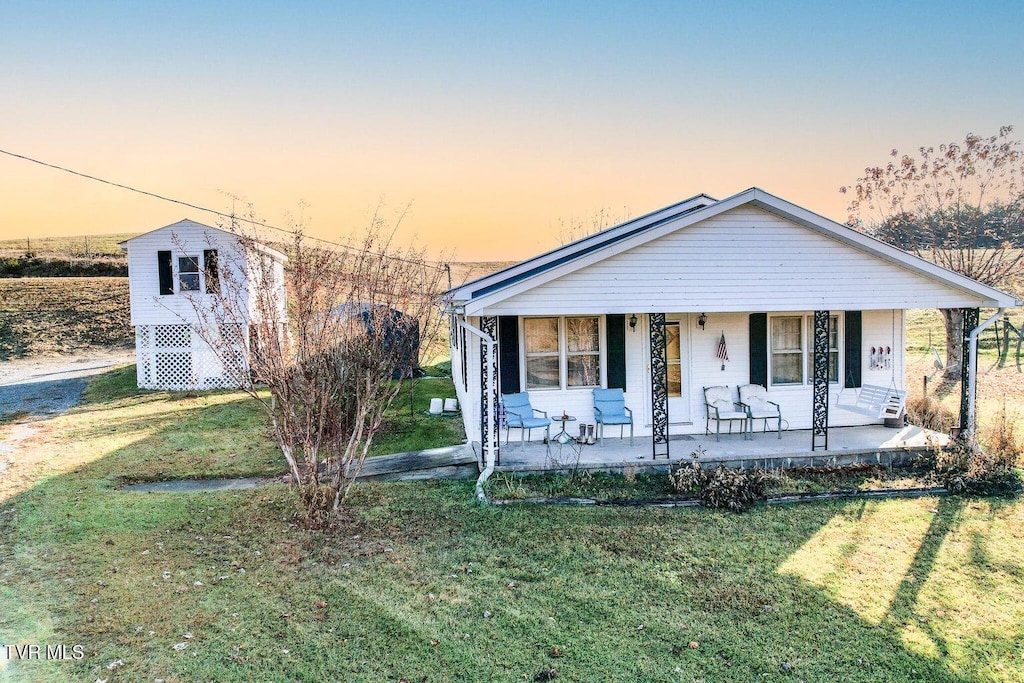 view of front facade featuring a yard and a porch