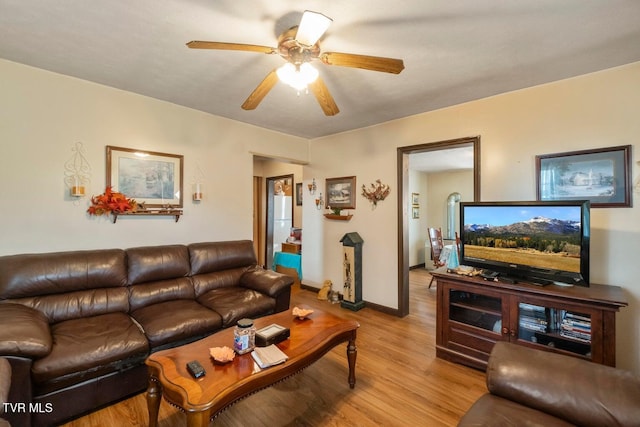 living room with ceiling fan and light wood-type flooring