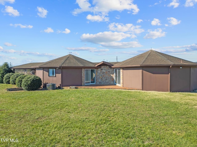 back of property with a lawn and central AC unit