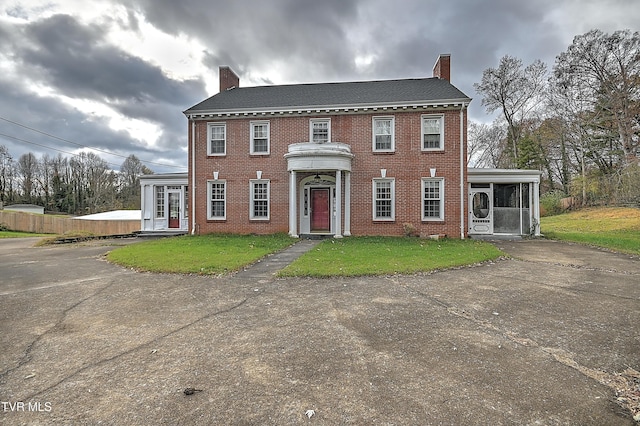 colonial-style house featuring a sunroom