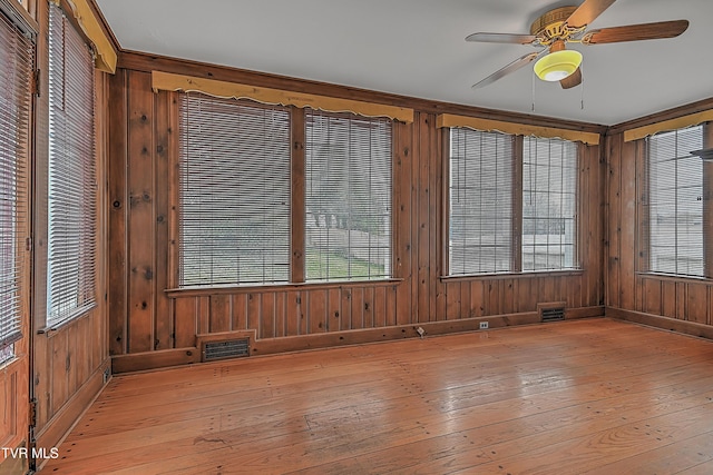 unfurnished sunroom with ceiling fan