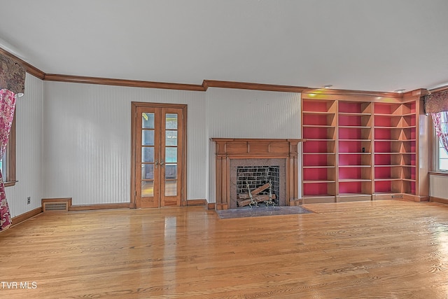 unfurnished living room featuring light hardwood / wood-style floors and ornamental molding