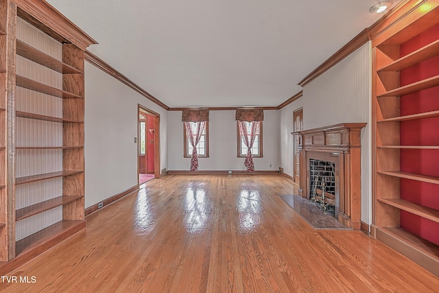 unfurnished living room featuring light wood-type flooring and crown molding