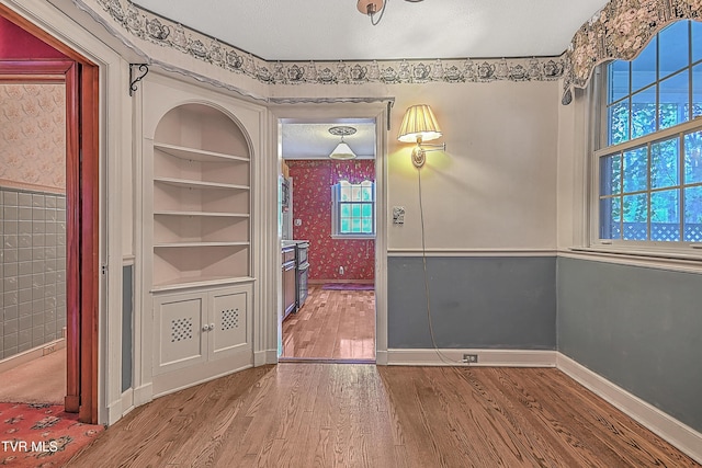 interior space featuring hardwood / wood-style flooring and a textured ceiling