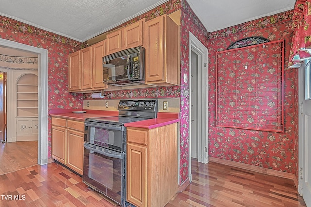 kitchen featuring black appliances, light hardwood / wood-style floors, ornamental molding, and a textured ceiling