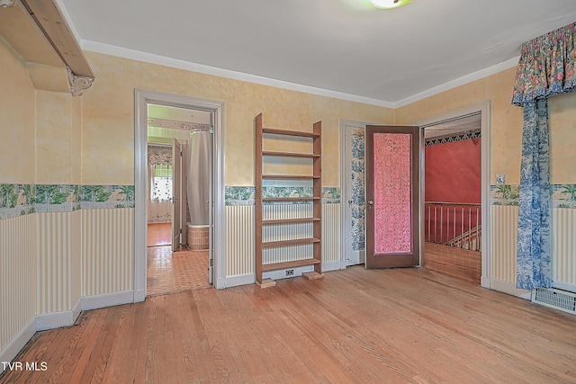 spare room featuring hardwood / wood-style floors and ornamental molding