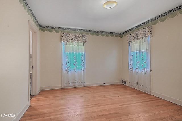 unfurnished room featuring light hardwood / wood-style floors