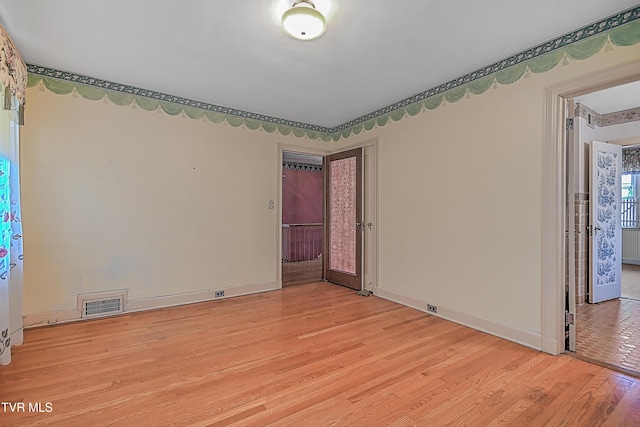 unfurnished room with light hardwood / wood-style floors