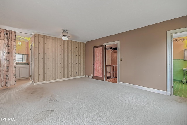 unfurnished room featuring carpet and ceiling fan