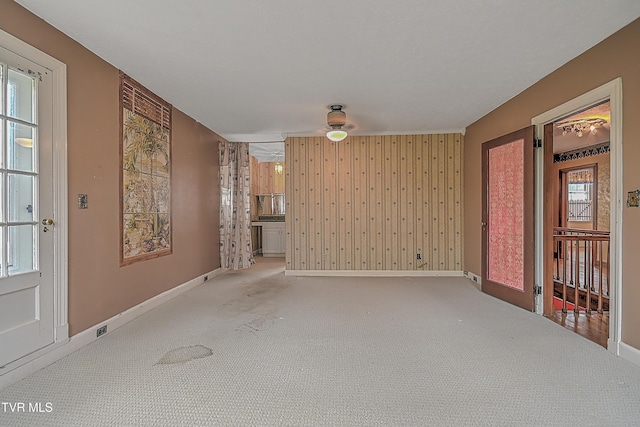 carpeted spare room with a wealth of natural light and ceiling fan