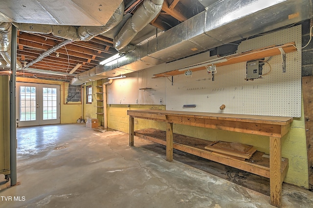 basement featuring a workshop area and french doors